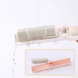 Portable washable reusable lint roller with foldable cat-themed design and detachable drum.