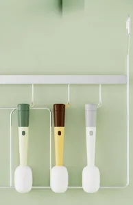 Close-up of three-in-one microphone-style cup brushes with lanyards hanging on a metal rack