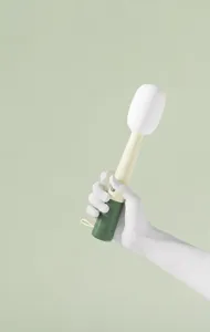 Close-up of a 3-in-1 microphone-shaped cup brush with an ergonomic rounded handle