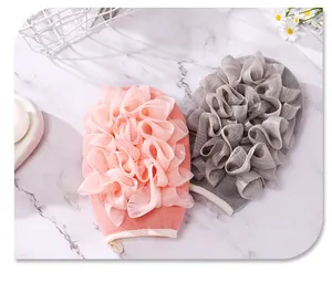 Detailansicht der rosa und grauen doppelseitigen Luffa-Badehandschuhe für sanftes Körperpeeling