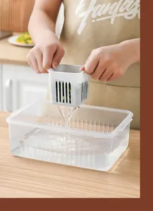 Kitchen scallion drainage box showing water draining from inner basket into outer container.