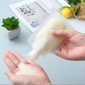 Detail view of portable frosted travel squeeze pouch dispensing lotion into palm.