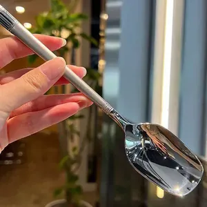 Close-up detail of mirror-polished stainless steel long handle lantern dessert spoon