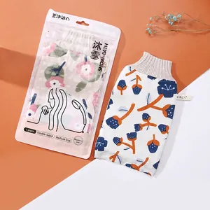Premium floral pattern double-sided exfoliating bath mitt shown with retail packaging