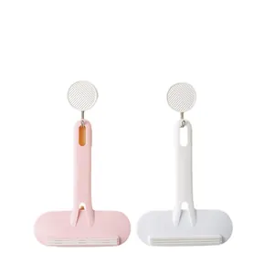 Manual double-sided lint remover set in pink and white colors with circular wall hooks for home