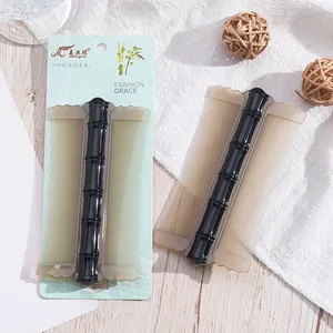 Fine-tooth pet flea comb with black bamboo-style handle, shown with retail packaging