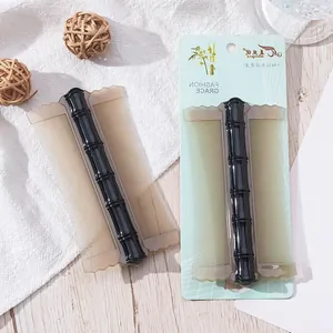 Detailed view of bamboo-shaped pet flea comb with fine teeth for cat and dog grooming