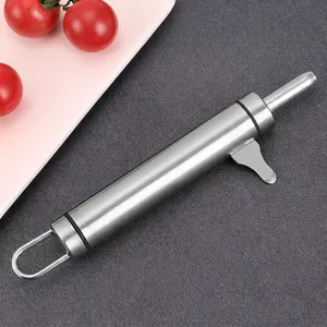 Close-up of stainless steel macadamia nut cracker tool on textured surface