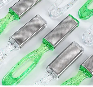 Detailed macro view of stainless steel foot files featuring green and clear glittery handles