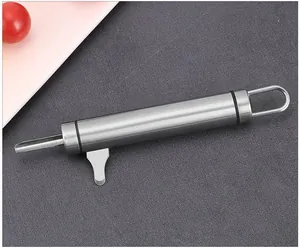 Macro view of a durable stainless steel macadamia nutcracker on a textured grey surface