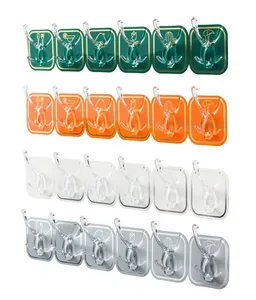 Close-up of rows of six self-adhesive hooks in green, orange, clear, and grey finishes