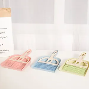 Detailed shot of mini broom and dustpan sets in various pastel colors for desktop use