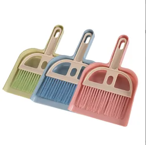 Set of three colorful mini brooms and dustpans for desk and keyboard cleaning