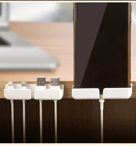 Dettaglio dell'organizzatore cavi in silicone per cavi usb e smartphone sulla scrivania