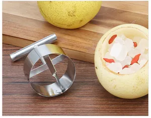 Stainless steel fruit corer divider tool shown with a prepared pear for healthy cooking
