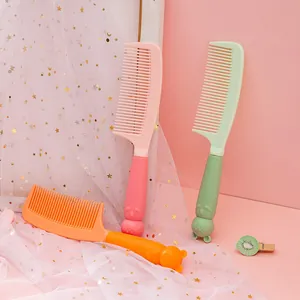 Close-up of cute cartoon cat and bear handle hair combs in vibrant pastel colors