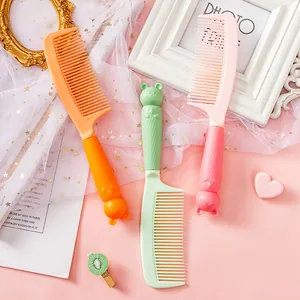 Detailed macro view of three cute cartoon cat handle hair combs in vibrant colors.