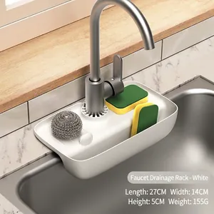 Detail of a white silicone faucet drain rack for sink storage with cleaning tools