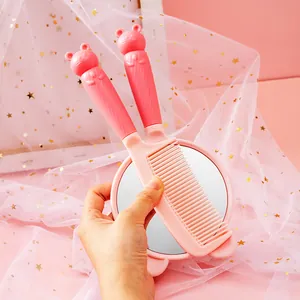 Adorable pink cartoon character hand-held makeup mirror and matching hair comb set