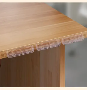 Clip per cavi in silicone trasparente montate sul bordo di una scrivania da ufficio