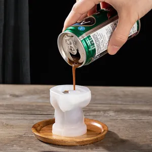 Cute bear-shaped silicone ice mold for coffee and cold drinks shown in use on rustic table