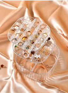 Detailed view of clear multi-tier jewelry organizer showing ring and bracelet compartments