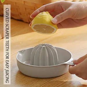 Manual lemon juicer press with curved teeth for efficient citrus fruit extraction