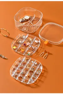 Macro view of transparent acrylic jewelry box with multiple compartments for rings