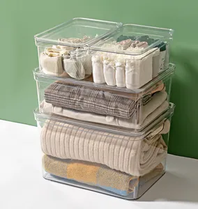 Stackable clear plastic storage bins for organizing clothing, socks and household items.