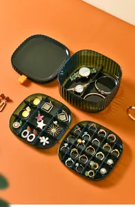 Multi-layered dark green jewelry storage boxes with specialized ring and watch compartments