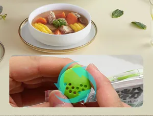 Close-up of green seasoning bag sealing clip featuring a rotating dispenser nozzle