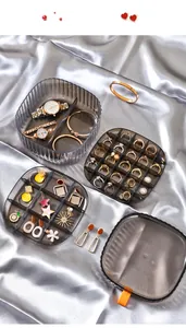 Detailed view of a multi-layer transparent grey jewelry storage box layout