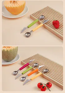 Close-up of double-headed stainless steel fruit carving tools on a wooden board