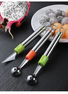 Close-up of stainless steel fruit baller and carving tools with fruit balls