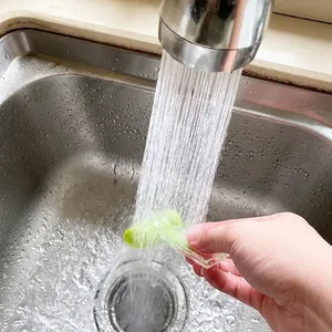 Green seasoning bag sealing clip being rinsed under water, waterproof kitchen tool