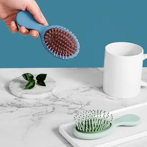 Mini spazzole per capelli portatili blu e verdi con cuscino d'aria per massaggio cute