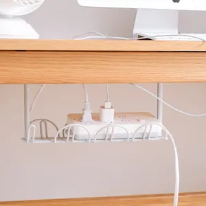 White under-desk metal cable management tray holding a power strip on a clean wooden desk.