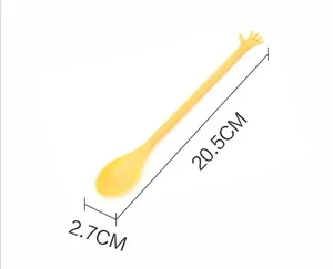 Technical detail view of yellow plastic honey stirrer showing 20.5cm length and 2.7cm width