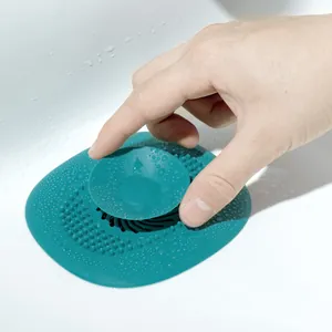 Close-up of teal silicone sink drain filter with suction lifting handle