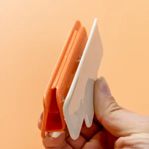 Handheld orange and white plastic food bag sealer clip for kitchen snack storage
