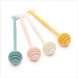 Set of four colorful plastic honey dippers and coffee stirrers with hand-shaped handles