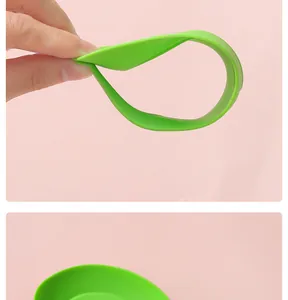 Flexible green silicone spoon rest kitchen tool showing durability and softness