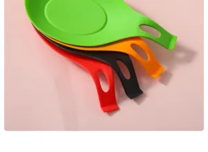 Detailed view of colorful heat-resistant silicone spoon rests for kitchen counter organization