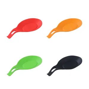 Detailed view of four colorful silicone spoon rests for kitchen utensil organization