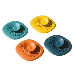 Four colorful silicone sink strainers and hair catchers for bathroom and kitchen drains.