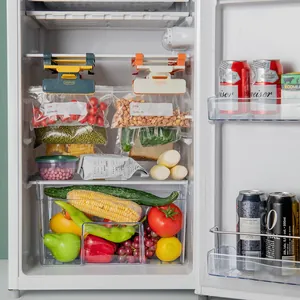 Hanging refrigerator storage rack with clips holding food bags for space-saving organization.