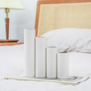 Set of four white tear-off lint roller refills in different sizes for laundry