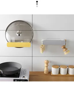 Wall-mounted retractable kitchen storage rack holding pot lid and cleaning tools