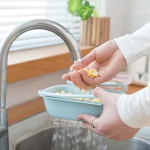 Light blue retractable kitchen sink colander basket for washing fresh vegetables and fruits