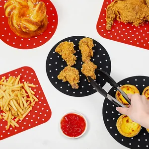 Reusable black and red silicone air fryer liners with perforated holes for snacks and food